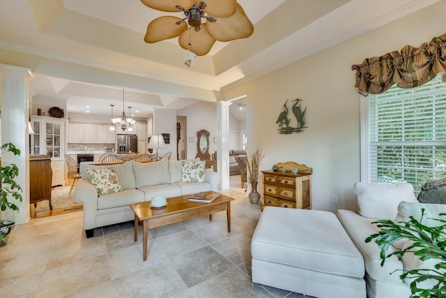 901 Patriots Pt, Mccormick, SC 29835 - living room featuring decorative columns, a ceiling fan, a raised ceiling, a chandelier, and crown molding