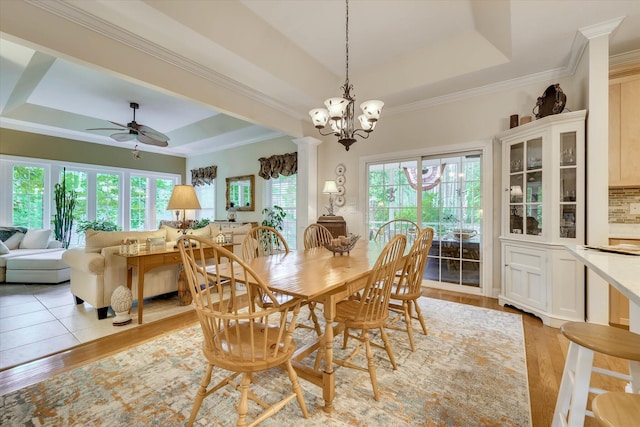 901 Patriots Pt, Mccormick, SC 29835 - dining area featuring a tray ceiling, light wood-style flooring, ornamental molding, a chandelier, and ceiling fan