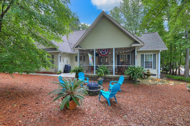 901 Patriots Pt, Mccormick, SC 29835 - view of front of house featuring roof with shingles, a fire pit, and a sunroom