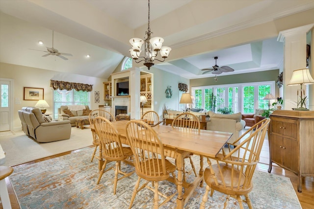 901 Patriots Pt, Mccormick, SC 29835 - dining space with a ceiling fan, a tile fireplace, a raised ceiling, vaulted ceiling, and light wood finished floors