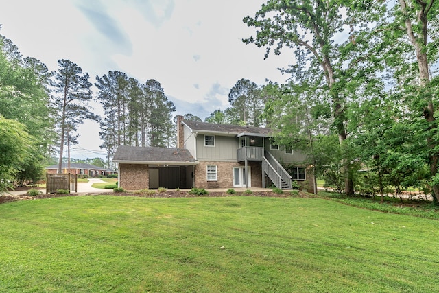 3247 Ramsgate Rd, Augusta, GA 30909 - rear view of property with stairs, a lawn, brick siding, and a chimney