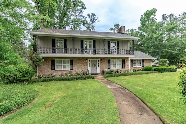 3247 Ramsgate Rd, Augusta, GA 30909 - view of front of house with a chimney, a front lawn, brick siding, a balcony, and board and batten siding