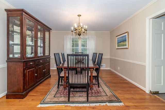 3247 Ramsgate Rd, Augusta, GA 30909 - dining room with a chandelier, light wood finished floors, baseboards, and ornamental molding