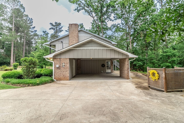 3247 Ramsgate Rd, Augusta, GA 30909 - view of home's exterior with driveway, a chimney, brick siding, an attached carport, and board and batten siding