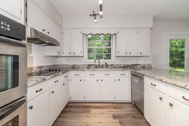 3247 Ramsgate Rd, Augusta, GA 30909 - kitchen featuring stainless steel appliances, under cabinet range hood, healthy amount of natural light, and white cabinets
