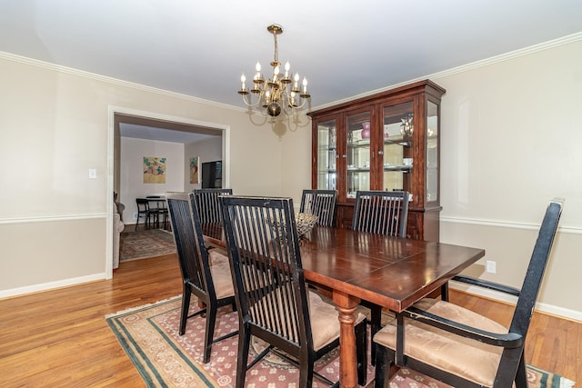 3247 Ramsgate Rd, Augusta, GA 30909 - dining room with a chandelier, light wood-style flooring, ornamental molding, and baseboards
