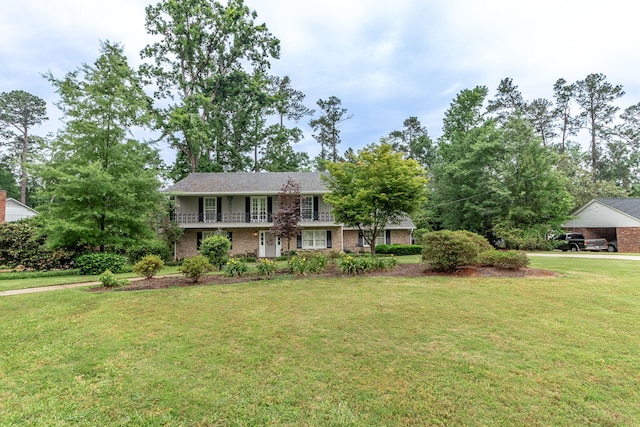 3247 Ramsgate Rd, Augusta, GA 30909 - view of front facade featuring a front lawn, brick siding, and a carport