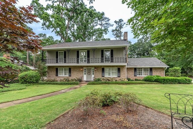 3247 Ramsgate Rd, Augusta, GA 30909 - view of front facade featuring a chimney, a balcony, a front yard, and board and batten siding