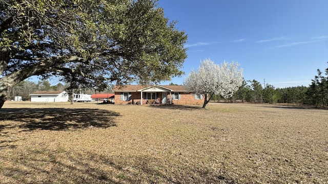 view of front of house with brick siding and a front lawn