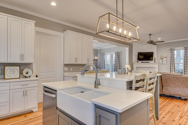 kitchen with white cabinets, ceiling fan, and sink