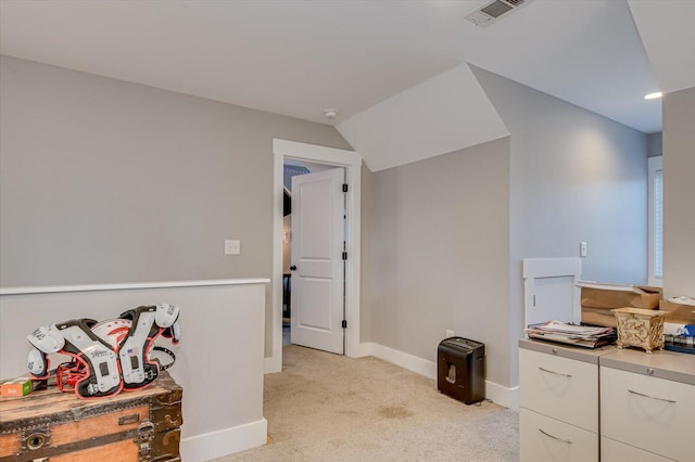 hall featuring light carpet and vaulted ceiling