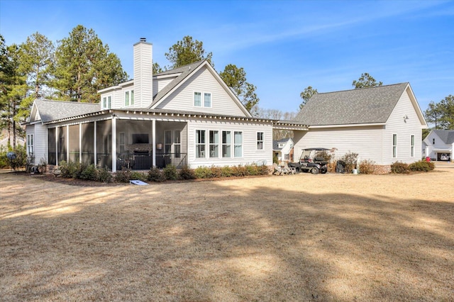 back of house featuring a sunroom