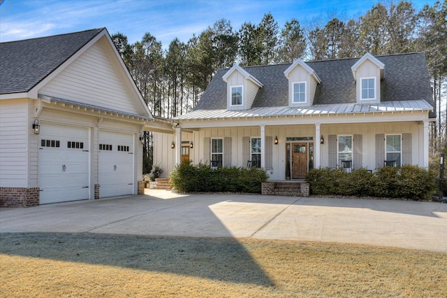 view of front facade featuring a porch, a front yard, and a garage