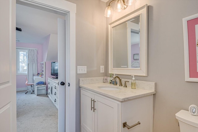 bathroom with toilet and vanity