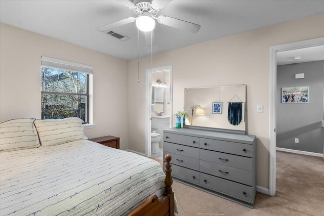 carpeted bedroom with connected bathroom and ceiling fan