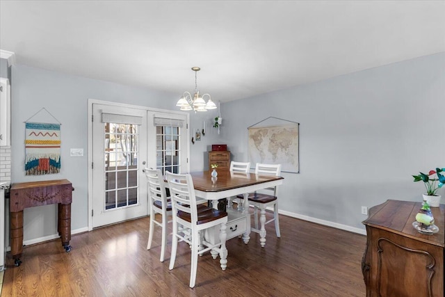 dining room featuring a notable chandelier, dark hardwood / wood-style flooring, and french doors