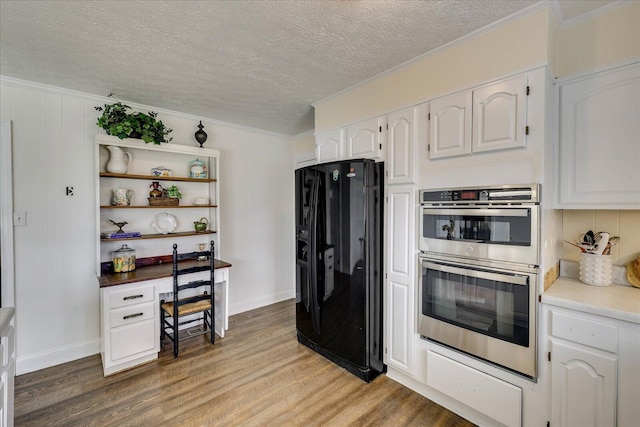 kitchen with open shelves, double oven, black refrigerator with ice dispenser, and light wood finished floors