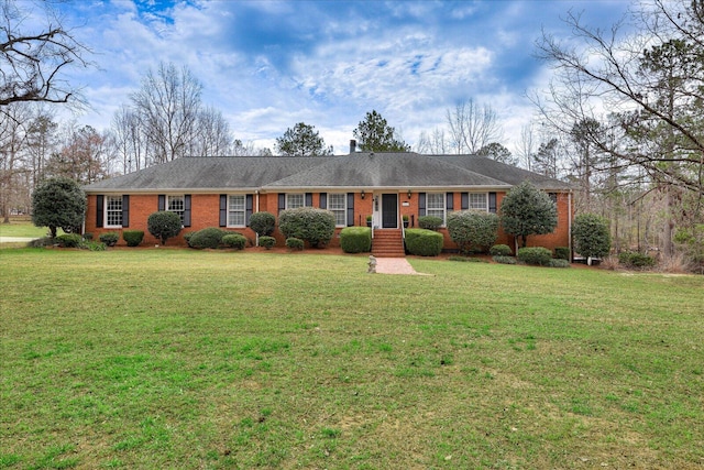 ranch-style house with brick siding and a front yard