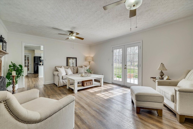 bedroom featuring access to outside, wood finished floors, freestanding refrigerator, french doors, and crown molding