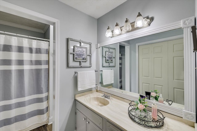 full bathroom featuring a shower with curtain, a textured ceiling, and vanity