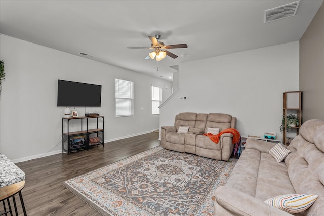 living room with dark wood-type flooring and ceiling fan