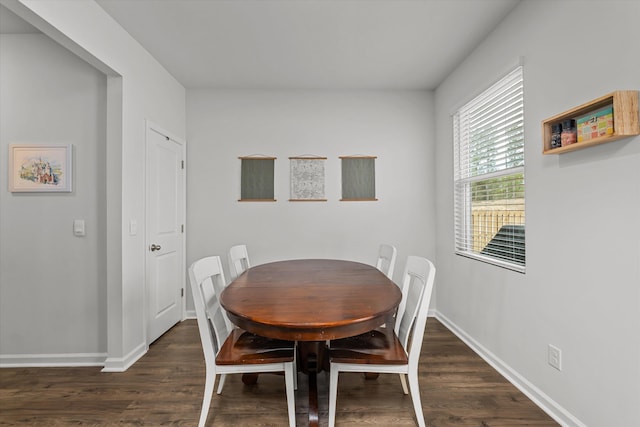 dining area with dark hardwood / wood-style flooring