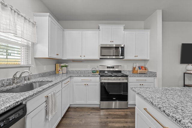 kitchen featuring white cabinetry, stainless steel appliances, sink, and light stone counters