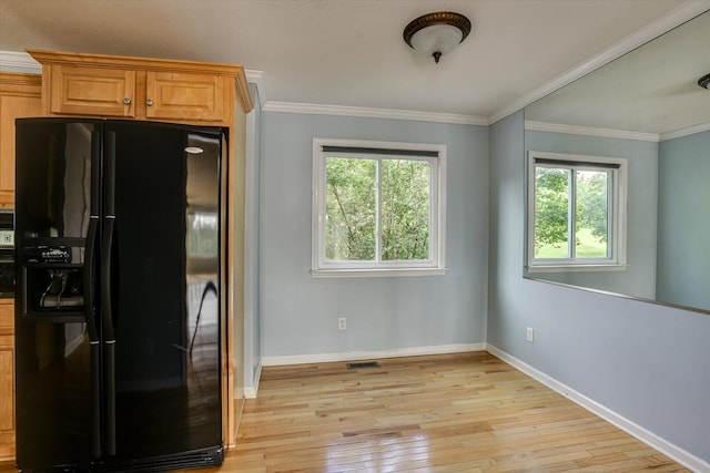 690 Riverfront Dr, Augusta, GA 30901 - kitchen with black fridge with ice dispenser, ornamental molding, visible vents, light wood-style floors, and baseboards