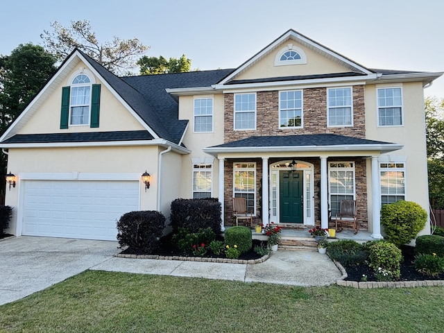 517 Avrett Ct, Evans, GA 30809 - traditional-style house featuring stone siding, stucco siding, driveway, and covered porch