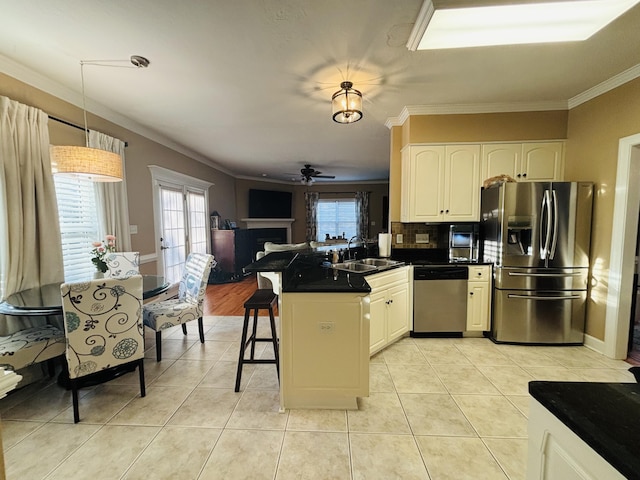 517 Avrett Ct, Evans, GA 30809 - kitchen with appliances with stainless steel finishes, crown molding, a sink, a peninsula, and dark countertops