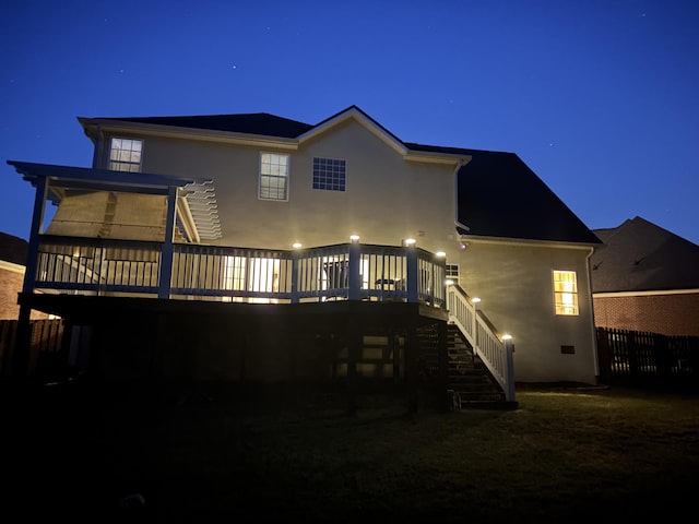 517 Avrett Ct, Evans, GA 30809 - back of house at twilight with stairs, a deck, and stucco siding