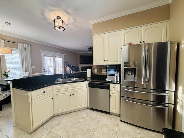 517 Avrett Ct, Evans, GA 30809 - kitchen featuring stainless steel appliances, a sink, a peninsula, ornamental molding, and dark countertops