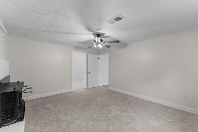 interior space featuring ceiling fan, a fireplace, and a textured ceiling