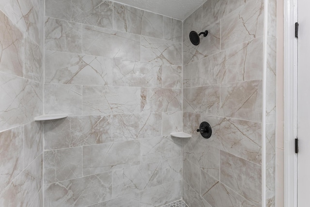 interior details with a tile shower