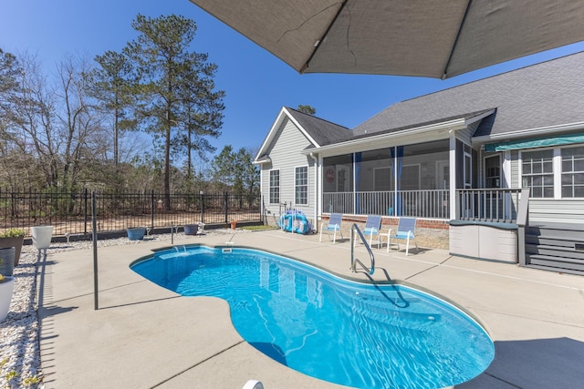 view of swimming pool with a patio, fence, a fenced in pool, and a sunroom