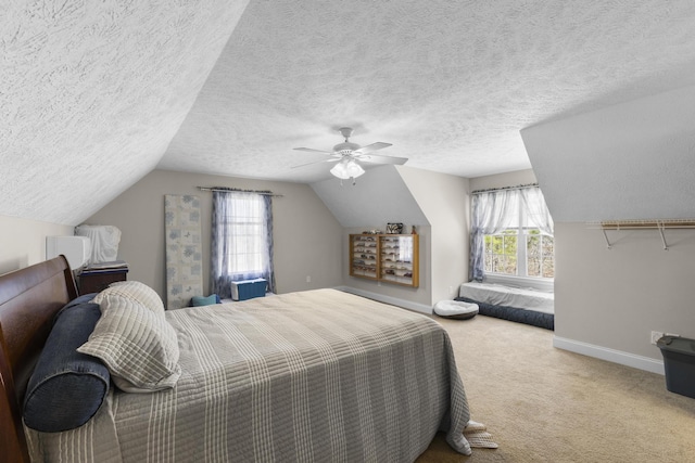 bedroom with ceiling fan, lofted ceiling, baseboards, and carpet floors