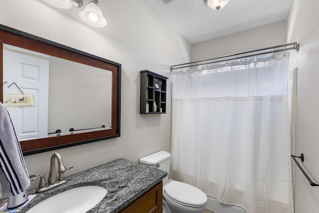 full bathroom with curtained shower, toilet, vanity, and a textured ceiling