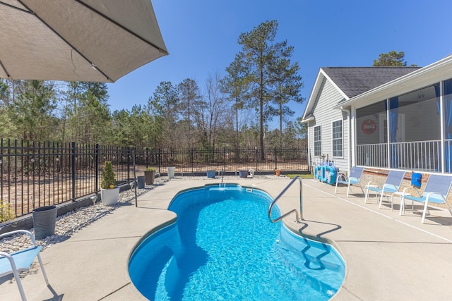 view of swimming pool with a fenced in pool, a sunroom, a patio, and fence