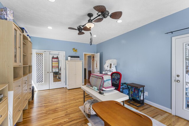 office space with recessed lighting, light wood-type flooring, baseboards, and ceiling fan