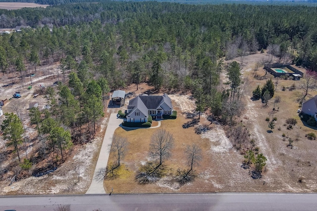 birds eye view of property with a forest view