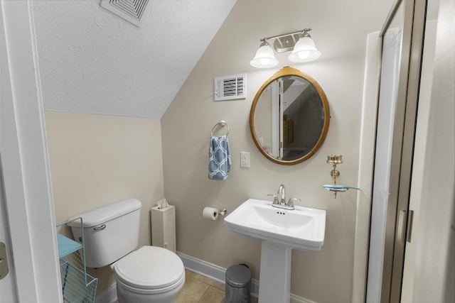 bathroom featuring visible vents, vaulted ceiling, a textured ceiling, tile patterned floors, and toilet