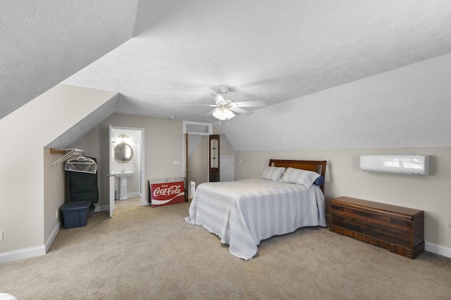 bedroom with a wall mounted air conditioner, carpet, and a textured ceiling