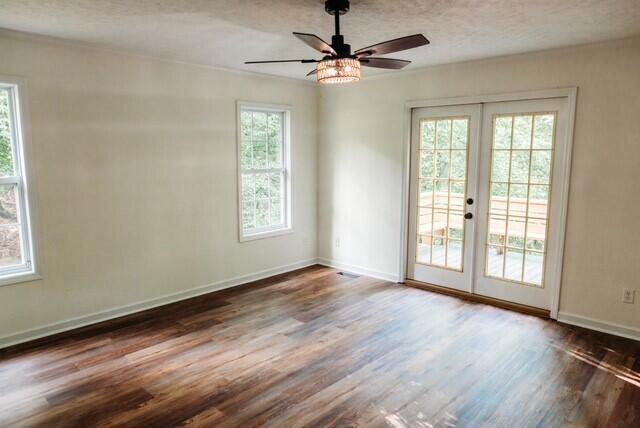 8643 Underwood Rd, Mitchell, GA 30820 - spare room featuring french doors, healthy amount of natural light, wood finished floors, and a textured ceiling