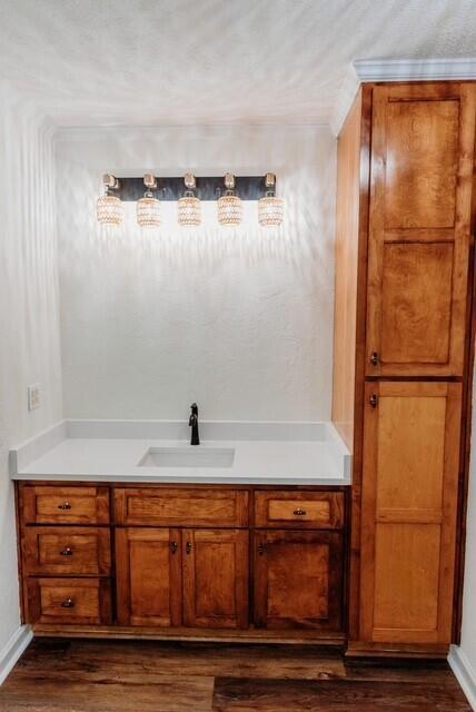 8643 Underwood Rd, Mitchell, GA 30820 - bathroom featuring wood finished floors, baseboards, and vanity