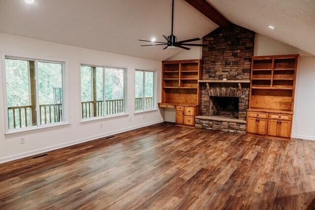 8643 Underwood Rd, Mitchell, GA 30820 - unfurnished living room with dark wood-style flooring, baseboards, a ceiling fan, and a stone fireplace