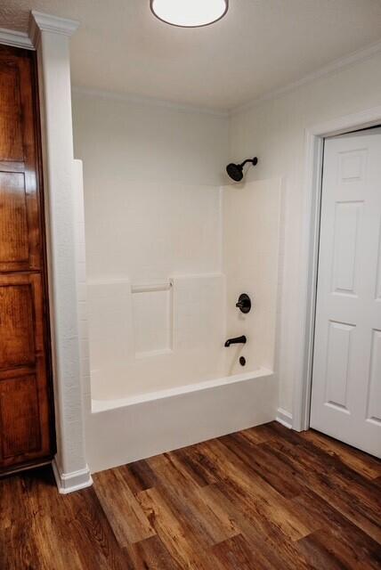 8643 Underwood Rd, Mitchell, GA 30820 - full bath featuring ornamental molding, wood finished floors, and tub / shower combination