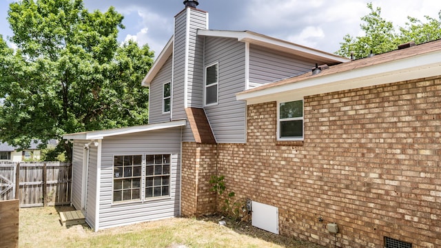 2154 Peppermint Pl, Augusta, GA 30906 - view of side of property with fence, a chimney, and brick siding
