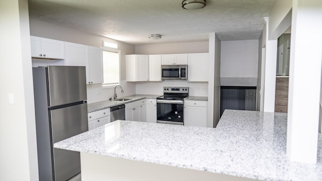 2154 Peppermint Pl, Augusta, GA 30906 - kitchen with a sink, stainless steel appliances, white cabinetry, light stone countertops, and decorative backsplash