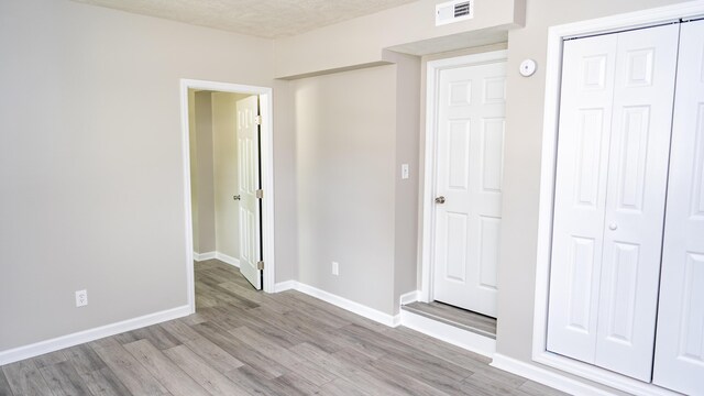 2154 Peppermint Pl, Augusta, GA 30906 - unfurnished bedroom with light wood-style floors, a closet, and baseboards
