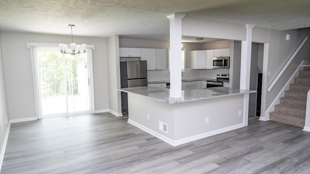 2154 Peppermint Pl, Augusta, GA 30906 - kitchen with appliances with stainless steel finishes, light wood-style floors, baseboards, white cabinets, and a textured ceiling
